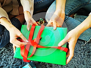 Man and Woman helping giftÃ¢â¬â¹ boxÃ¢â¬â¹ wrapping for Christmas New Year photo